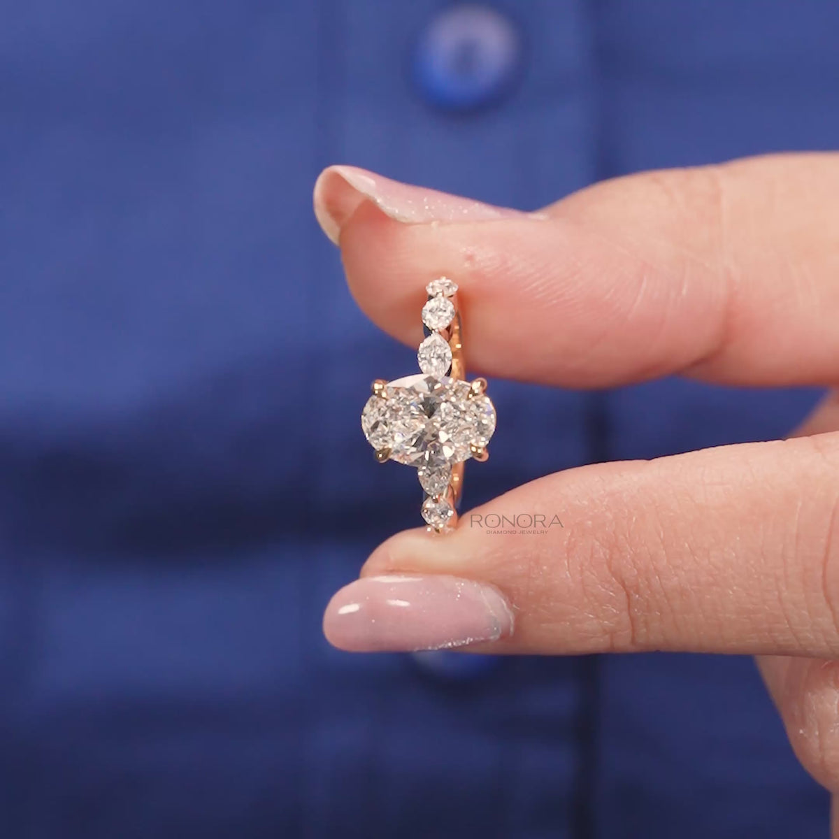 Close-up video of oval marquise lab grown diamond three-stone ring in yellow gold