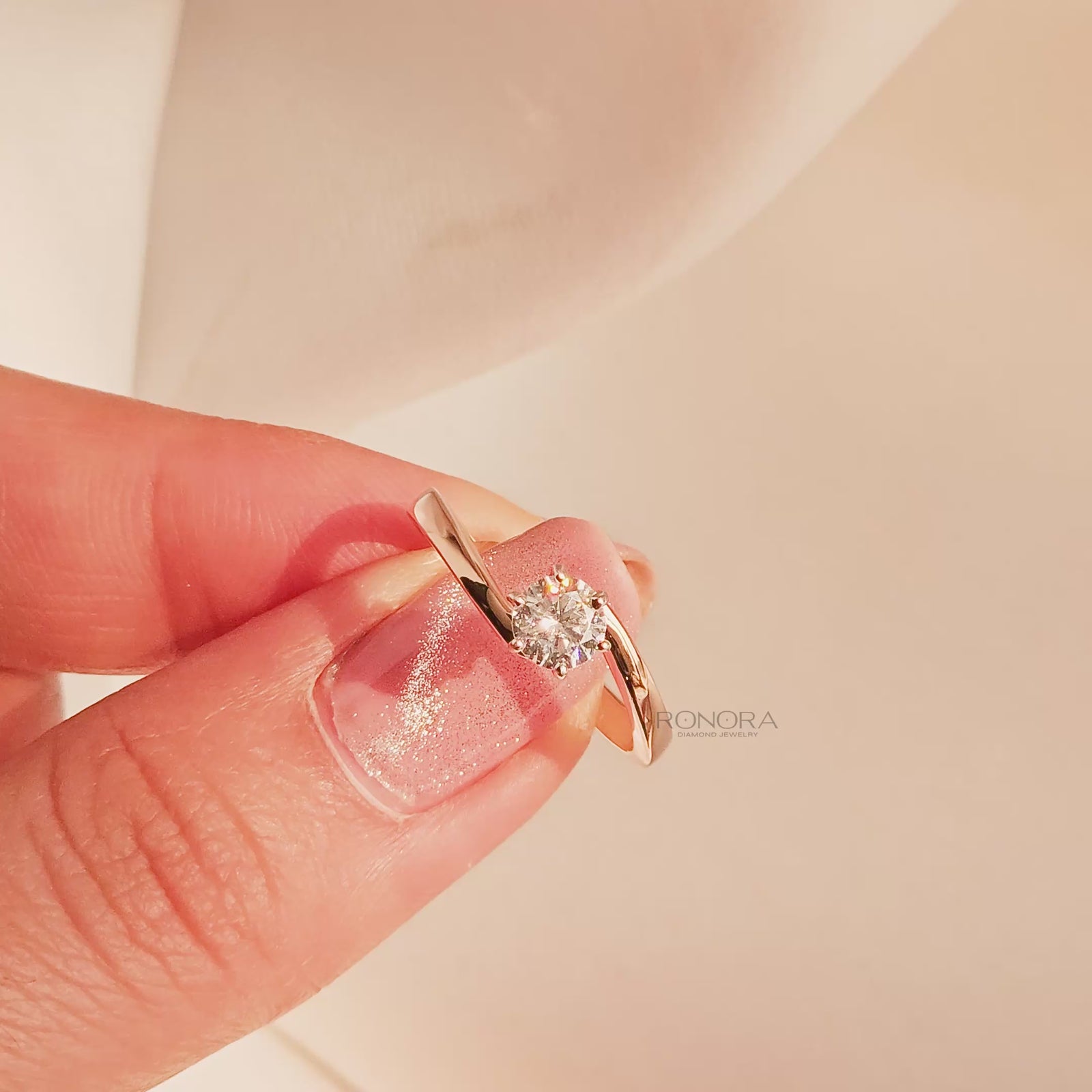Close-up video of round lab grown diamond bypass ring in rose gold