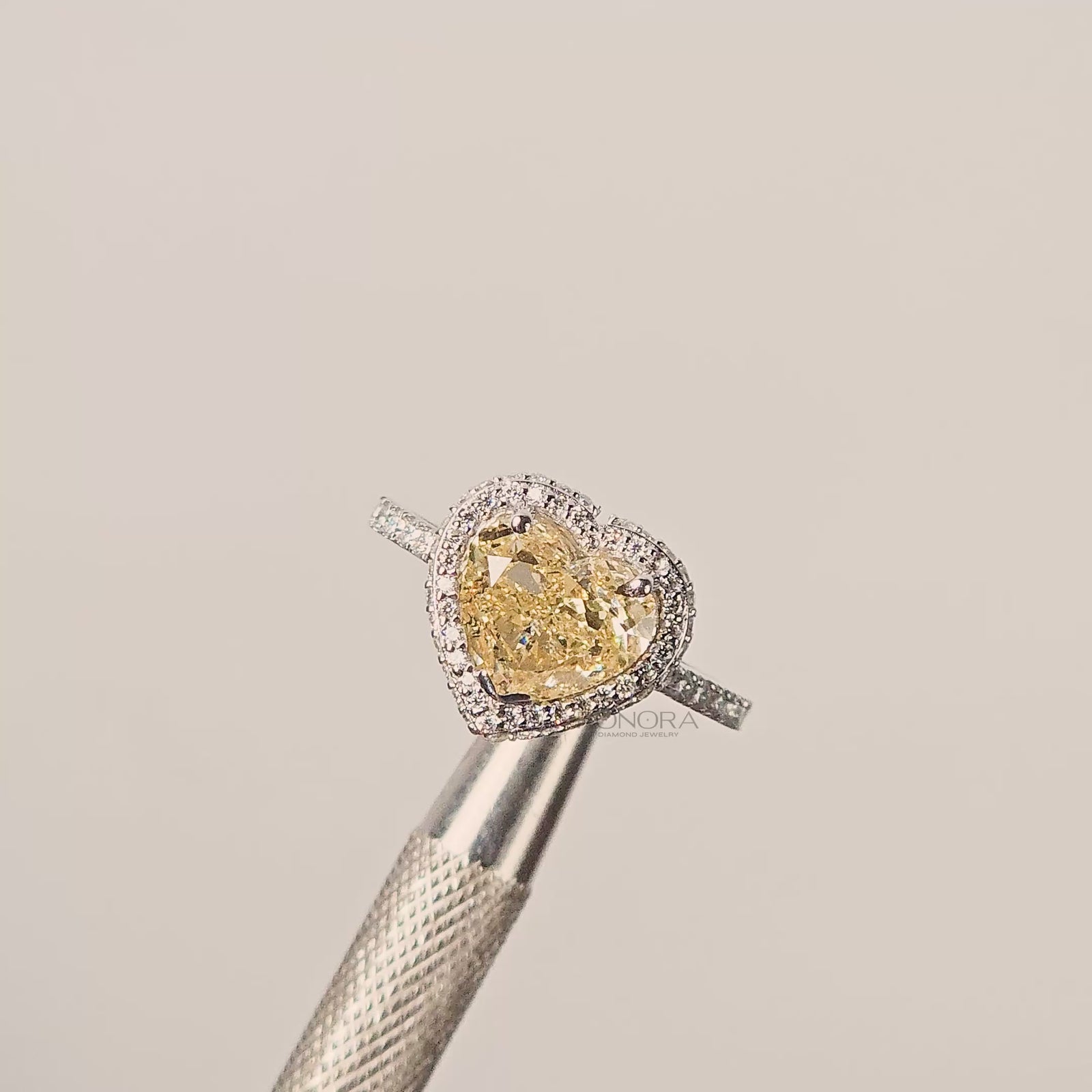 Close-up video of yellow heart lab grown diamond halo ring in white gold