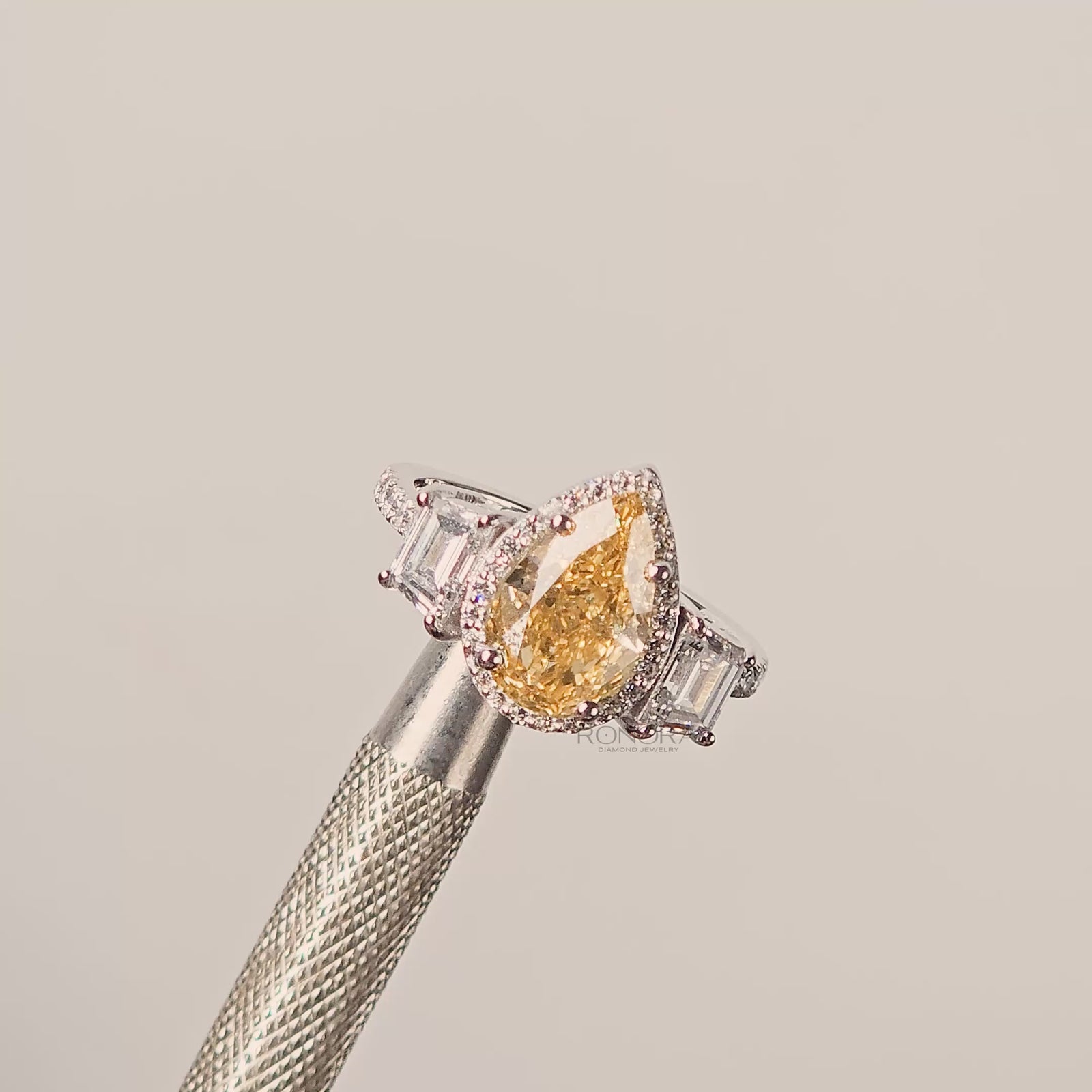Close-up video of yellow pear lab grown diamond halo ring in white gold