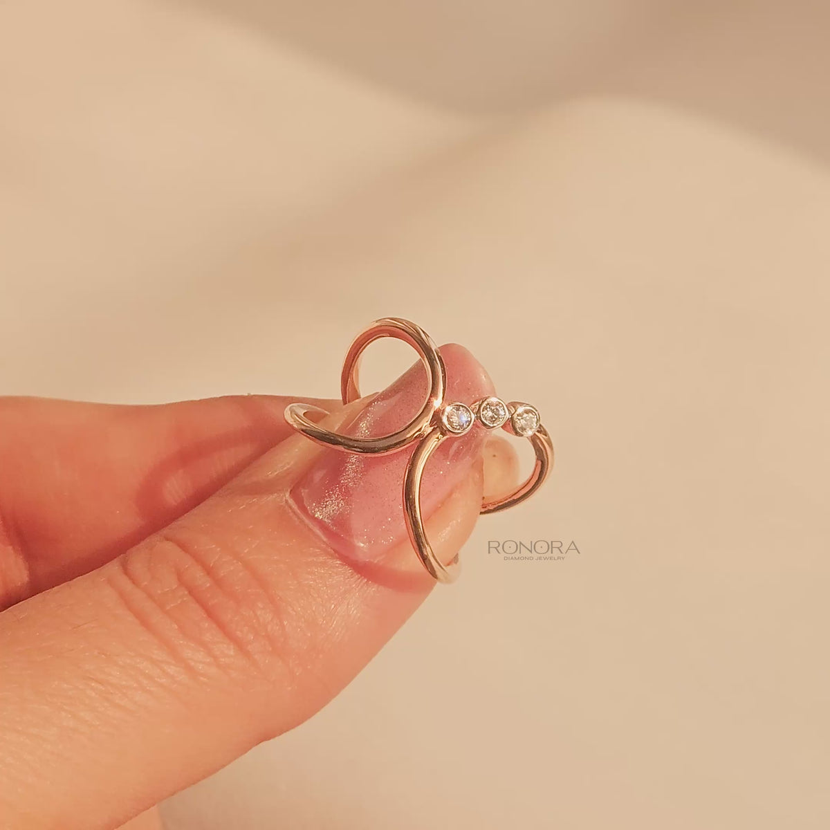 Close-up video of open lab grown diamond swirl ring in rose gold