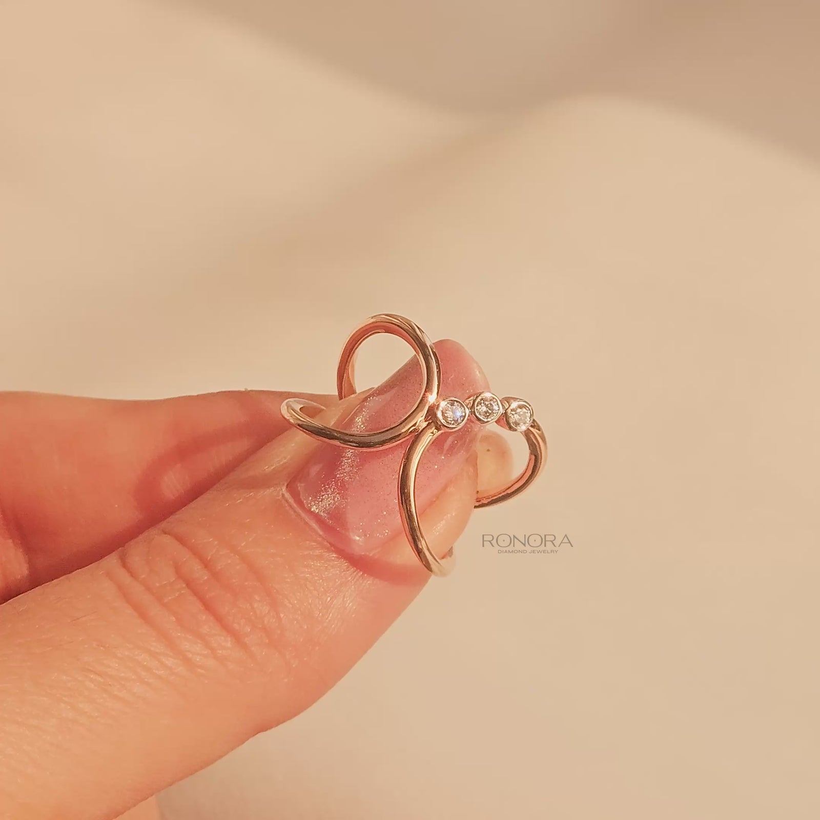 Close-up video of open lab grown diamond swirl ring in rose gold