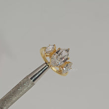 Close-up video of marquise lab grown diamond three-stone ring in yellow gold