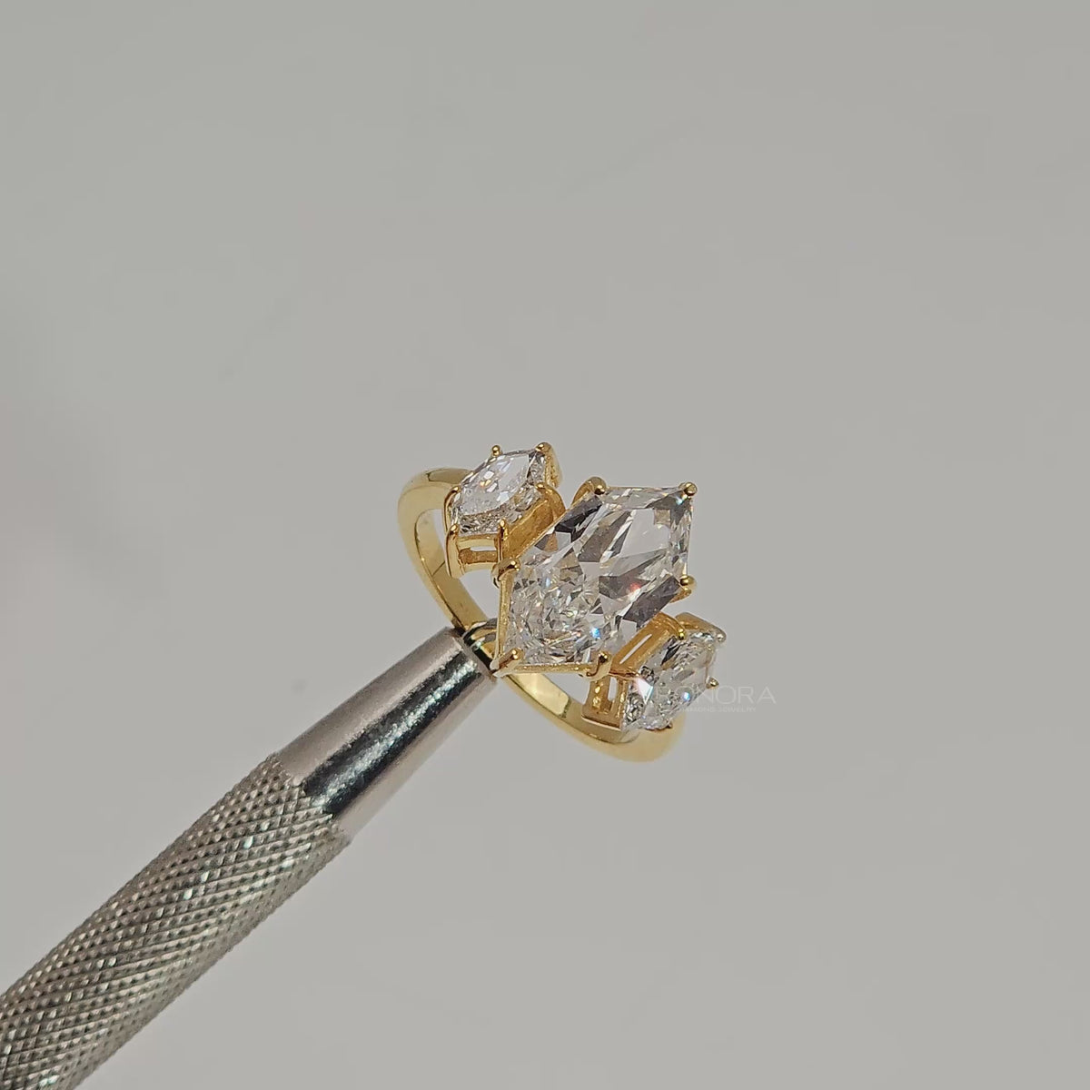 Close-up video of marquise lab grown diamond three-stone ring in yellow gold