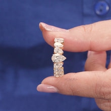 Close-up video of pear lab grown diamond five-stone band in yellow gold