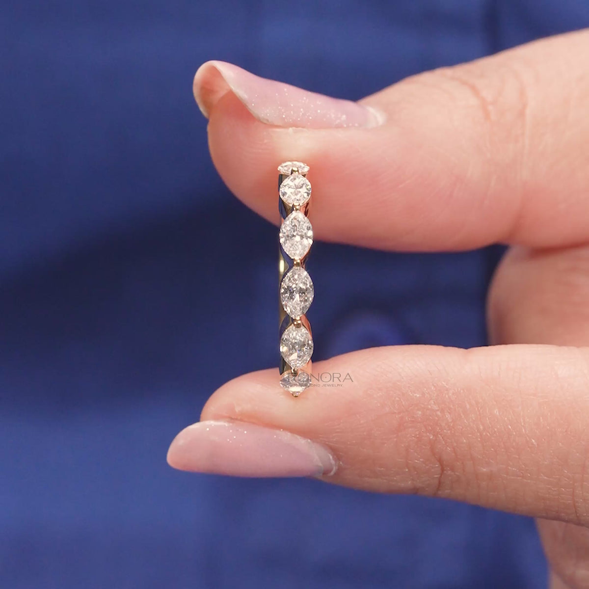 Close-up video of round lab grown diamond five-stone band in yellow gold