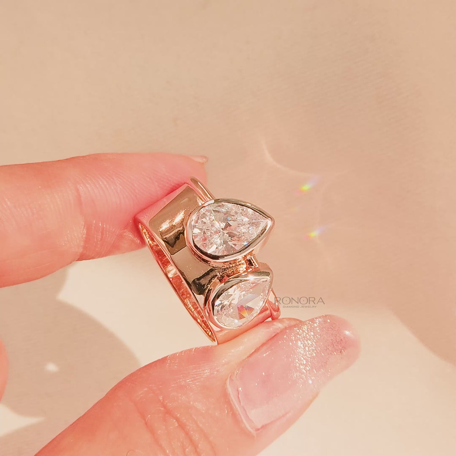Close-up video of pear lab grown diamond bypass ring in rose gold