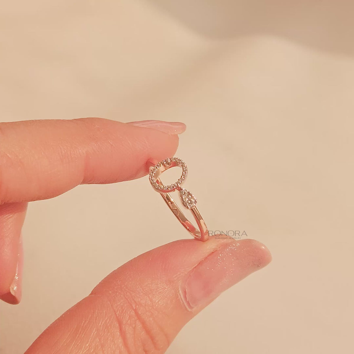 Close-up video of round lab grown diamond open halo ring in rose gold