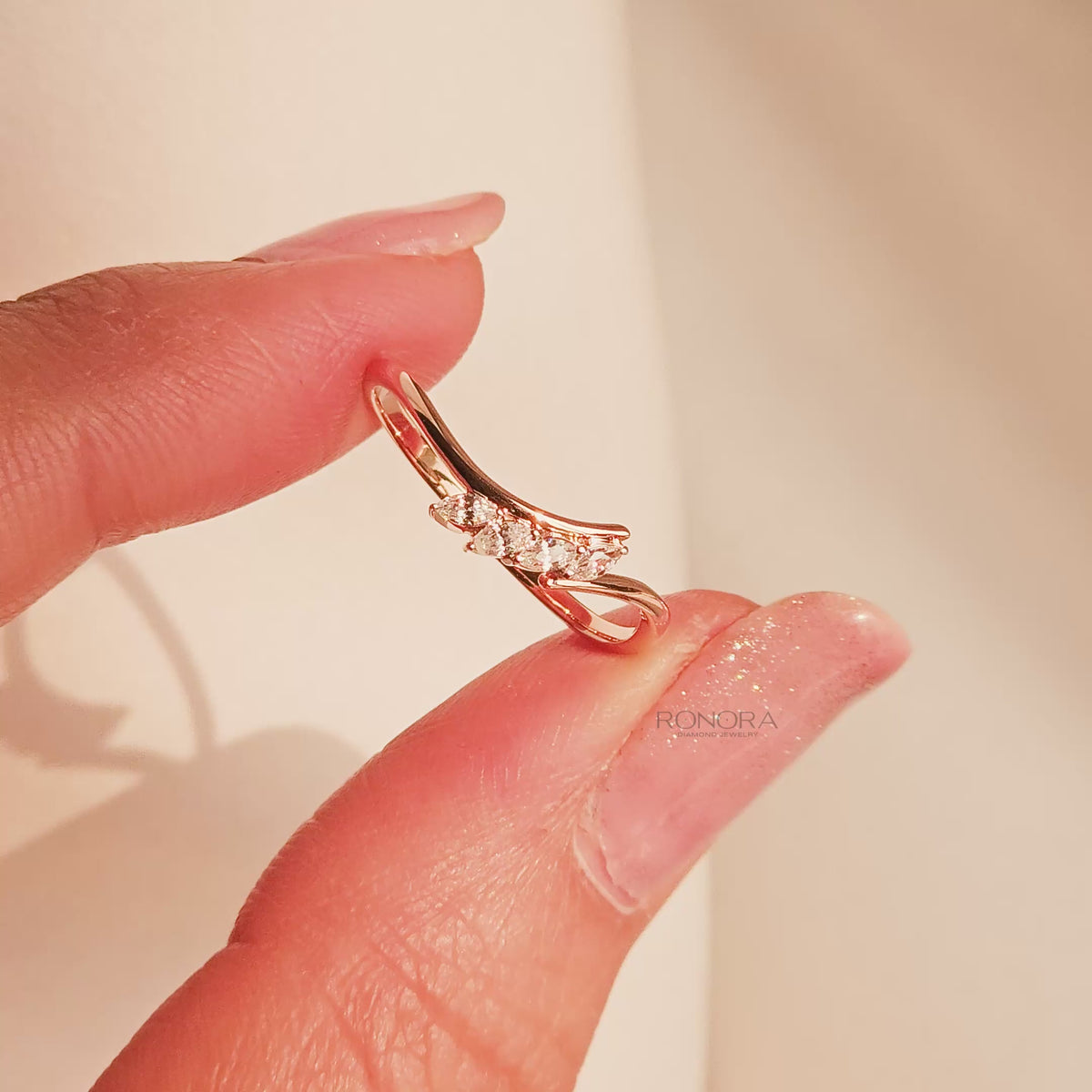 Close-up video of marquise lab grown diamond curved ring in rose gold