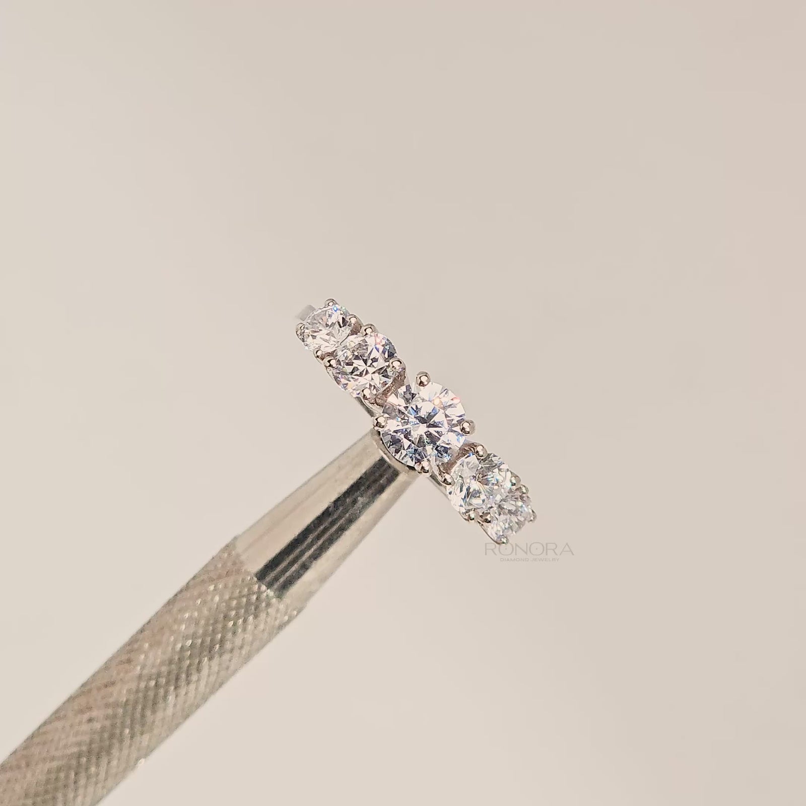 Close-up video of round lab grown diamond five-stone ring with graduated stones