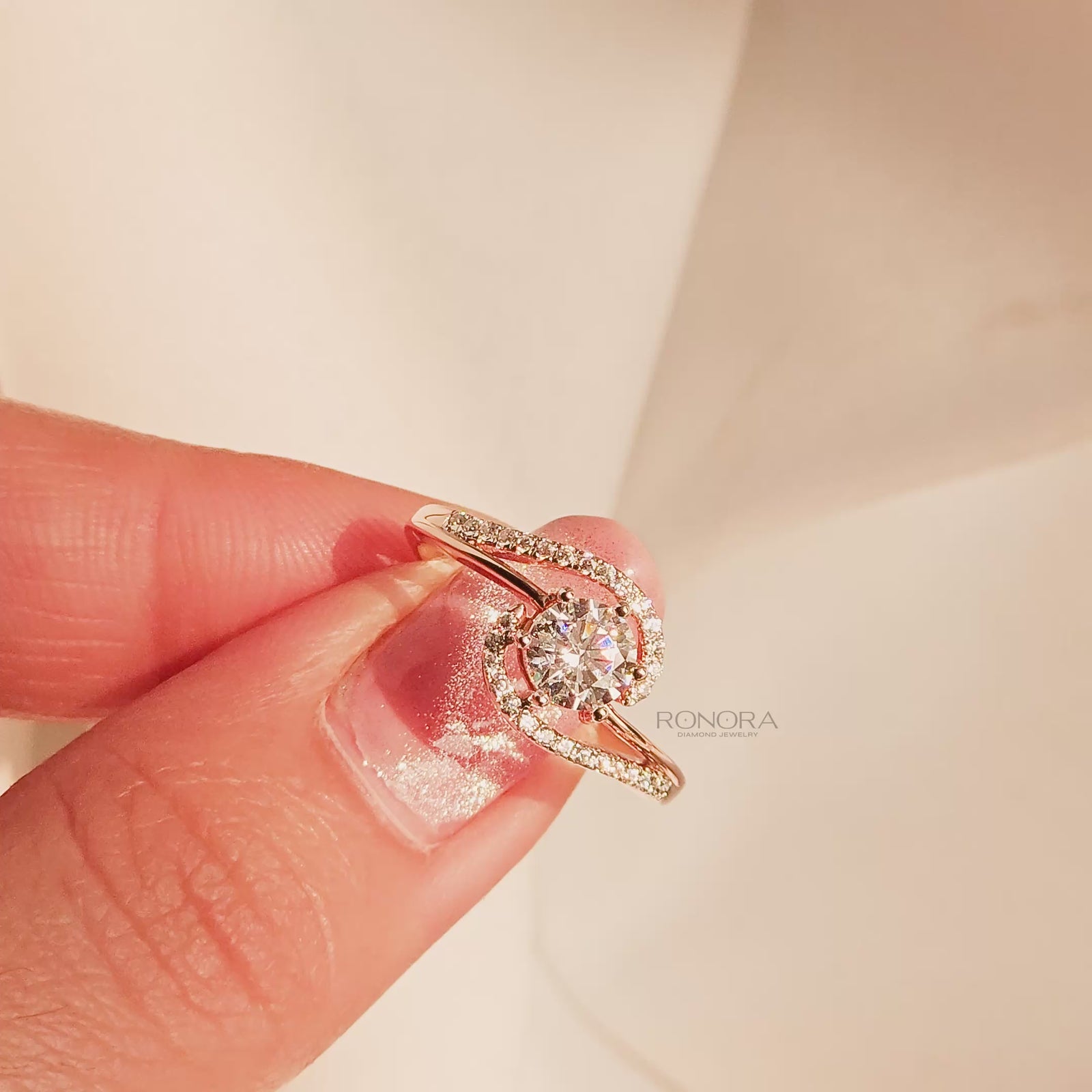 Close-up video of round lab grown diamond twisted pavé ring in rose gold