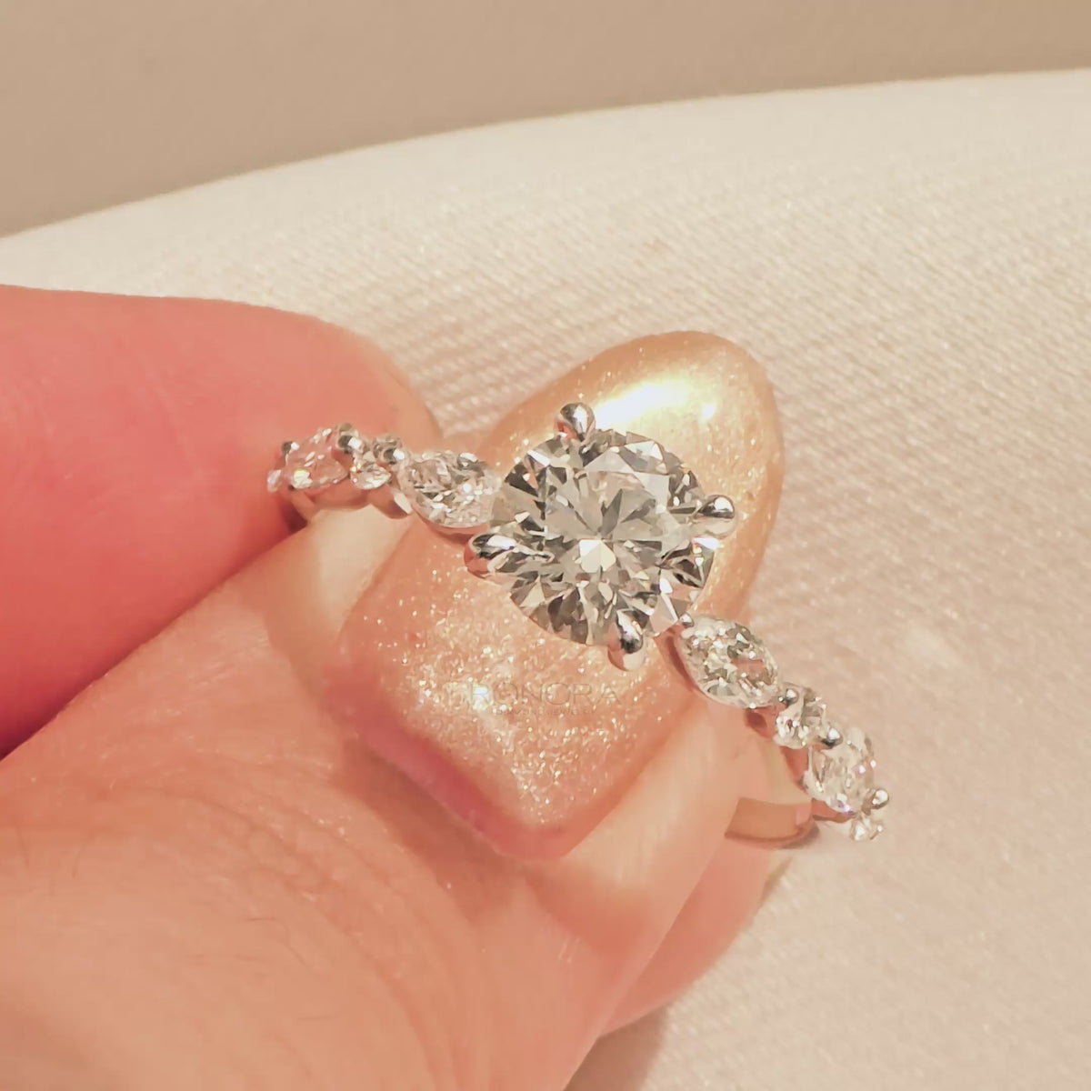Close-up video of round lab grown diamond side-stone ring in white gold