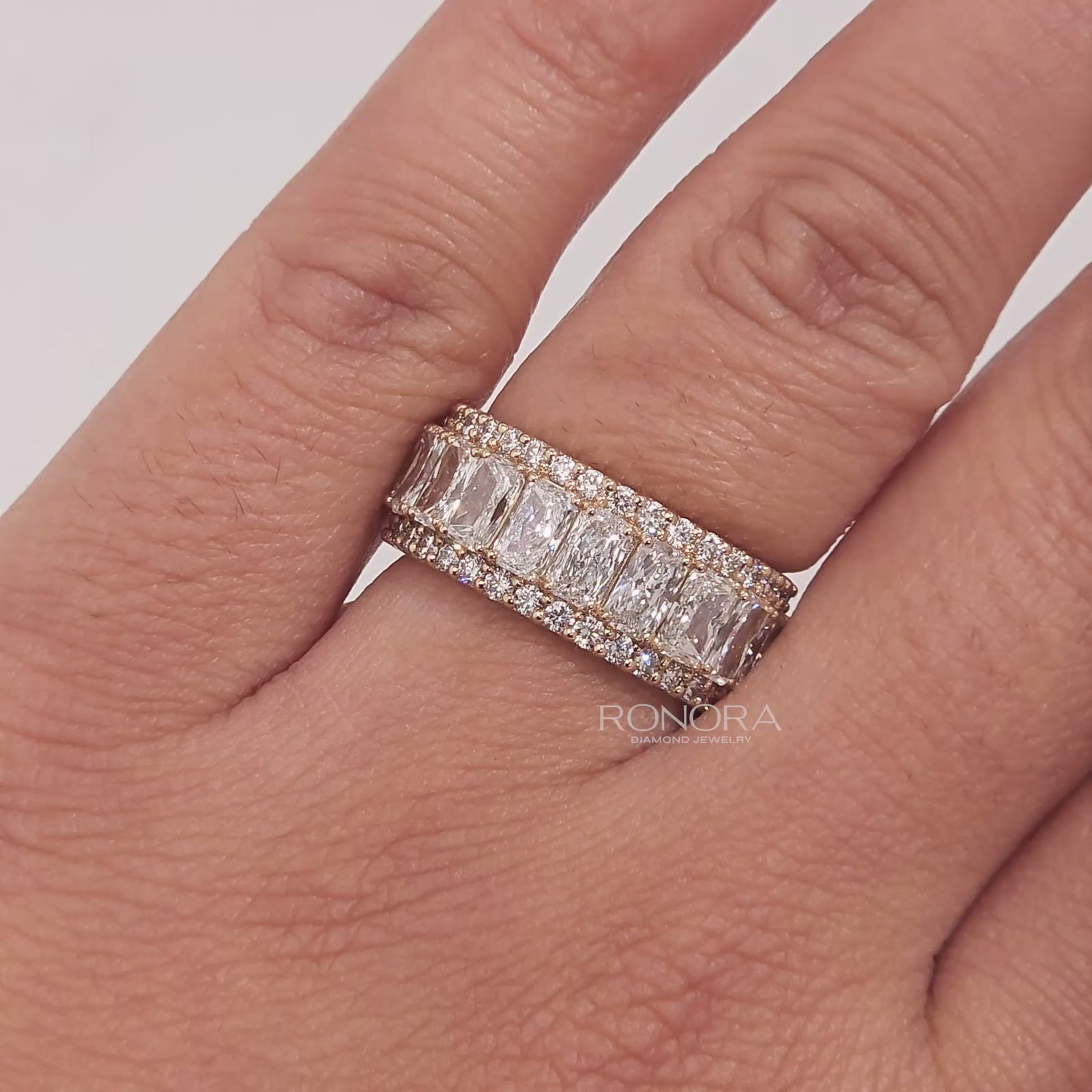 Close-up video of radiant lab grown diamond eternity band in yellow gold
