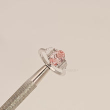 Close-up video of pink lab grown diamond three-stone ring in white metal
