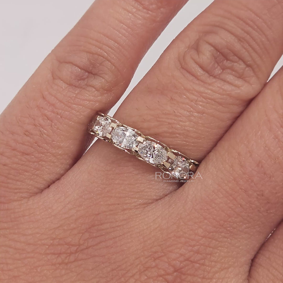 Close-up video of oval lab grown diamond eternity band in yellow gold