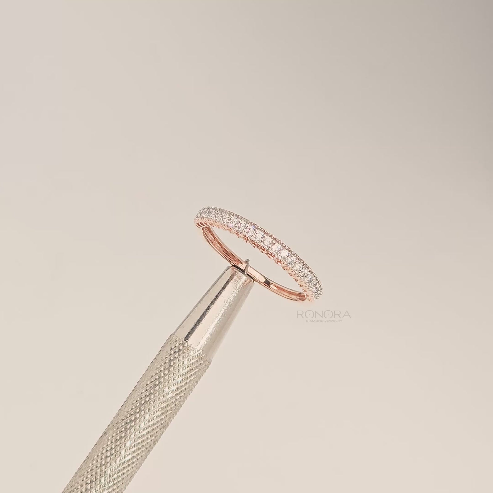 Close-up video of slim curved lab grown diamond pavé band in rose gold