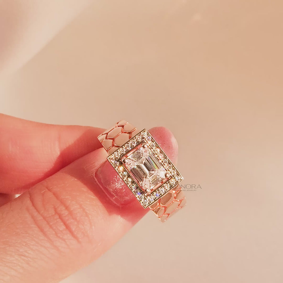 Close-up video of emerald moissanite halo men's ring in rose gold