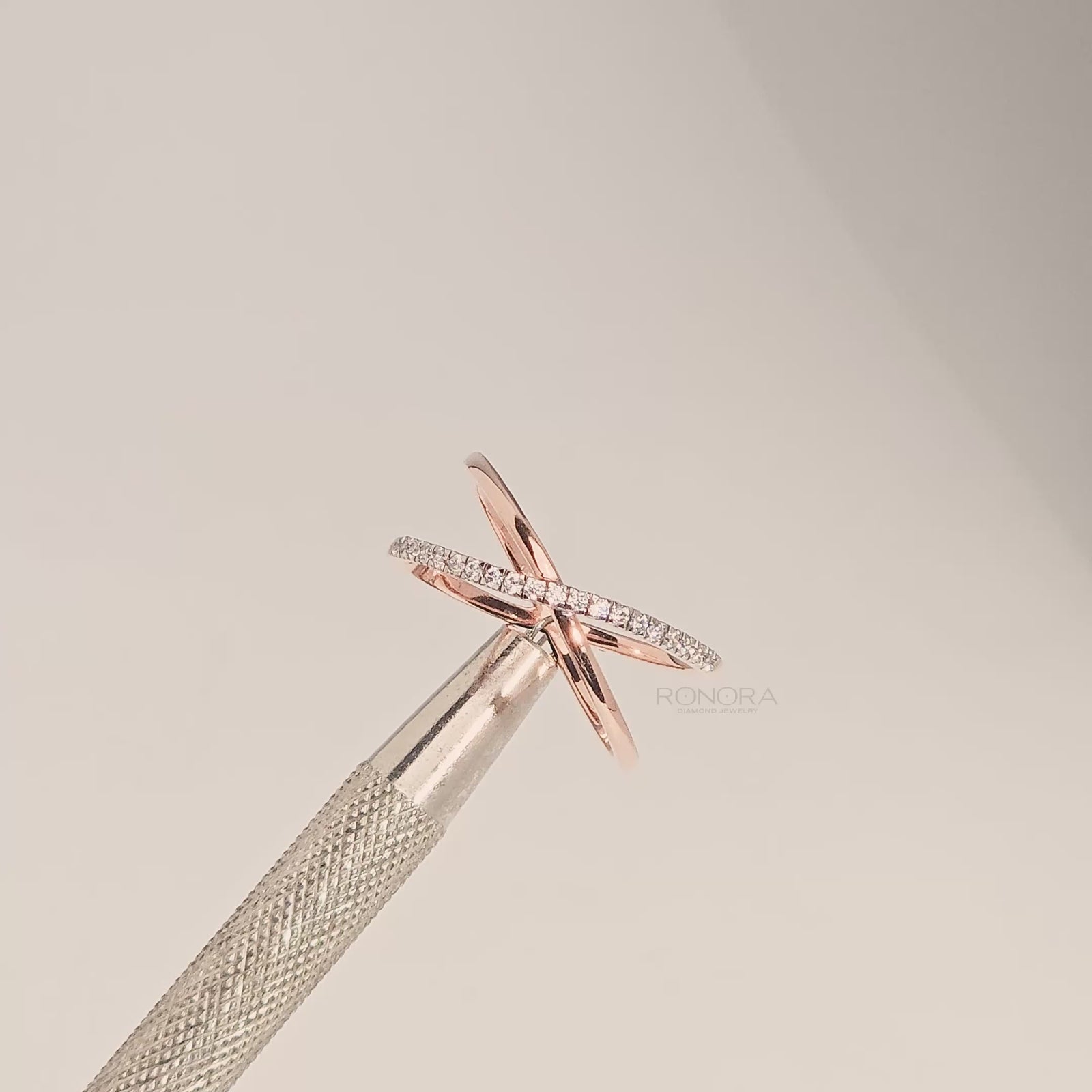 Close-up video of twisted lab grown diamond pavé crossover ring in rose gold