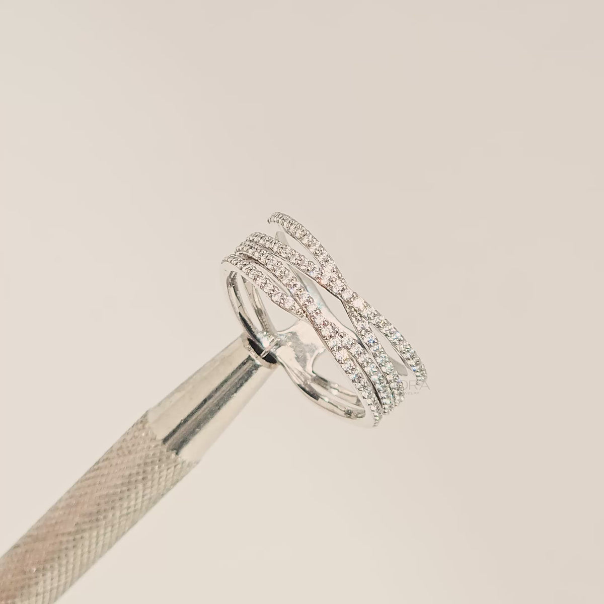 Close-up video of four-band lab grown diamond pavé crossover ring