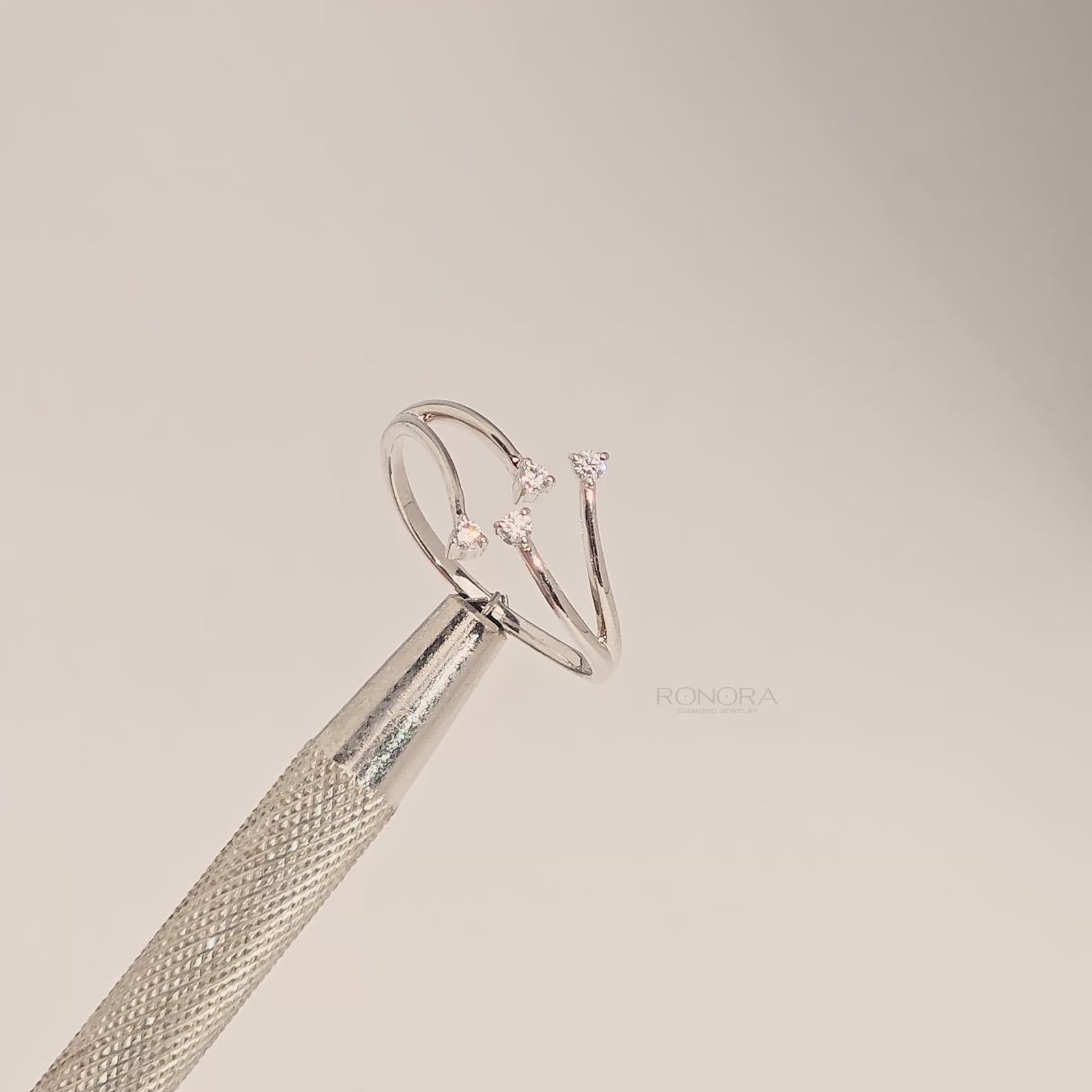 Close-up video of open bypass lab grown diamond ring with four round stones