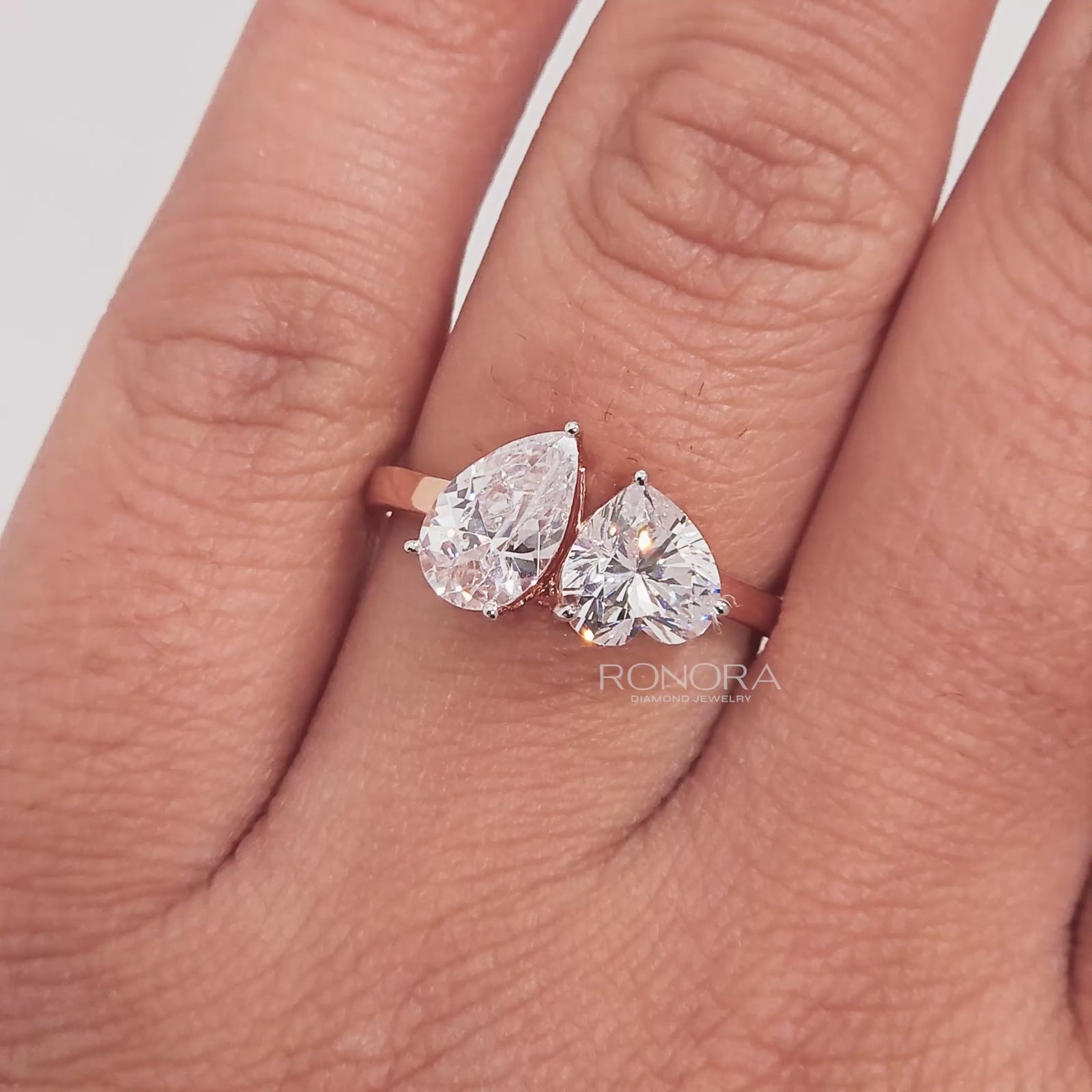 Close-up video of heart pear moissanite toi et moi ring in rose gold