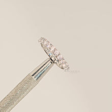 Close-up video of round lab grown diamond eternity band in white metal