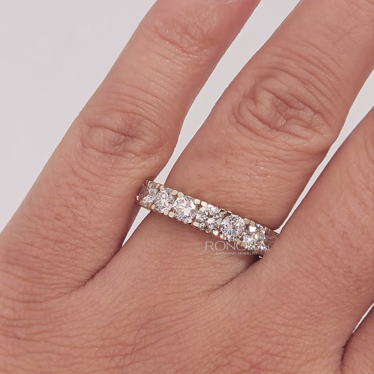Close-up video of round lab grown diamond eternity band in white gold