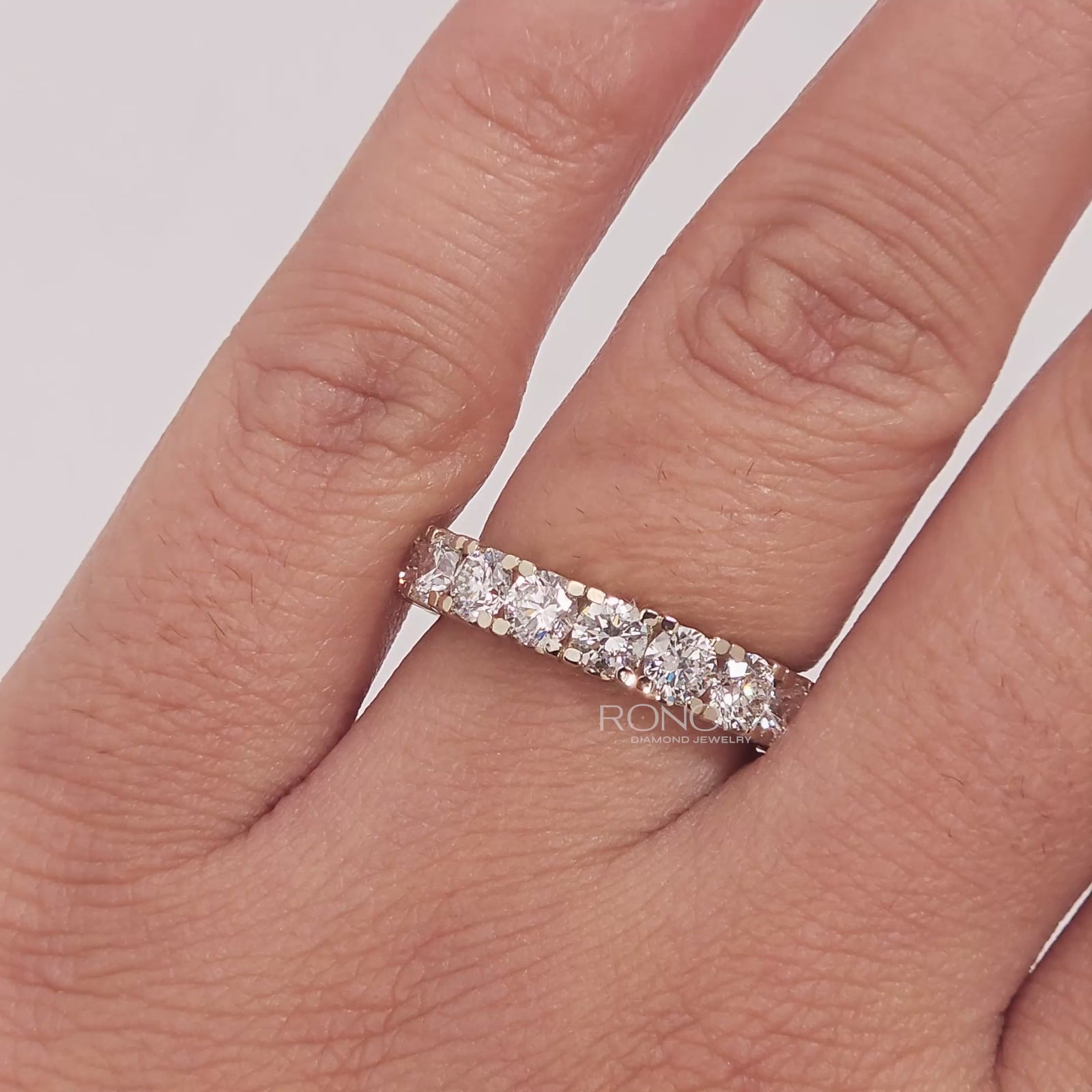 Close-up video of round lab grown diamond eternity band in white gold