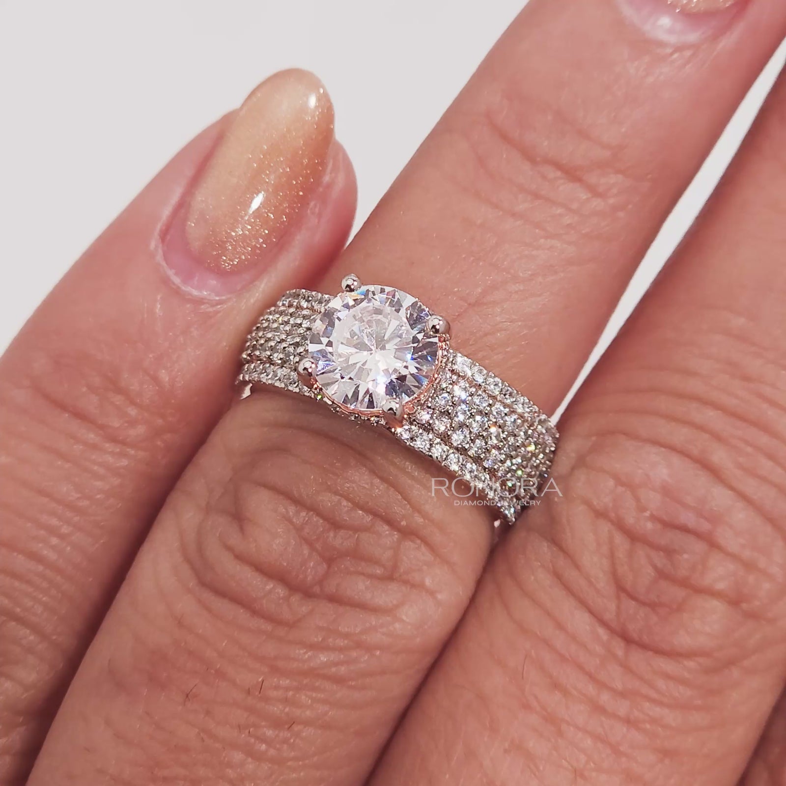Close-up video of round moissanite pave ring in rose gold