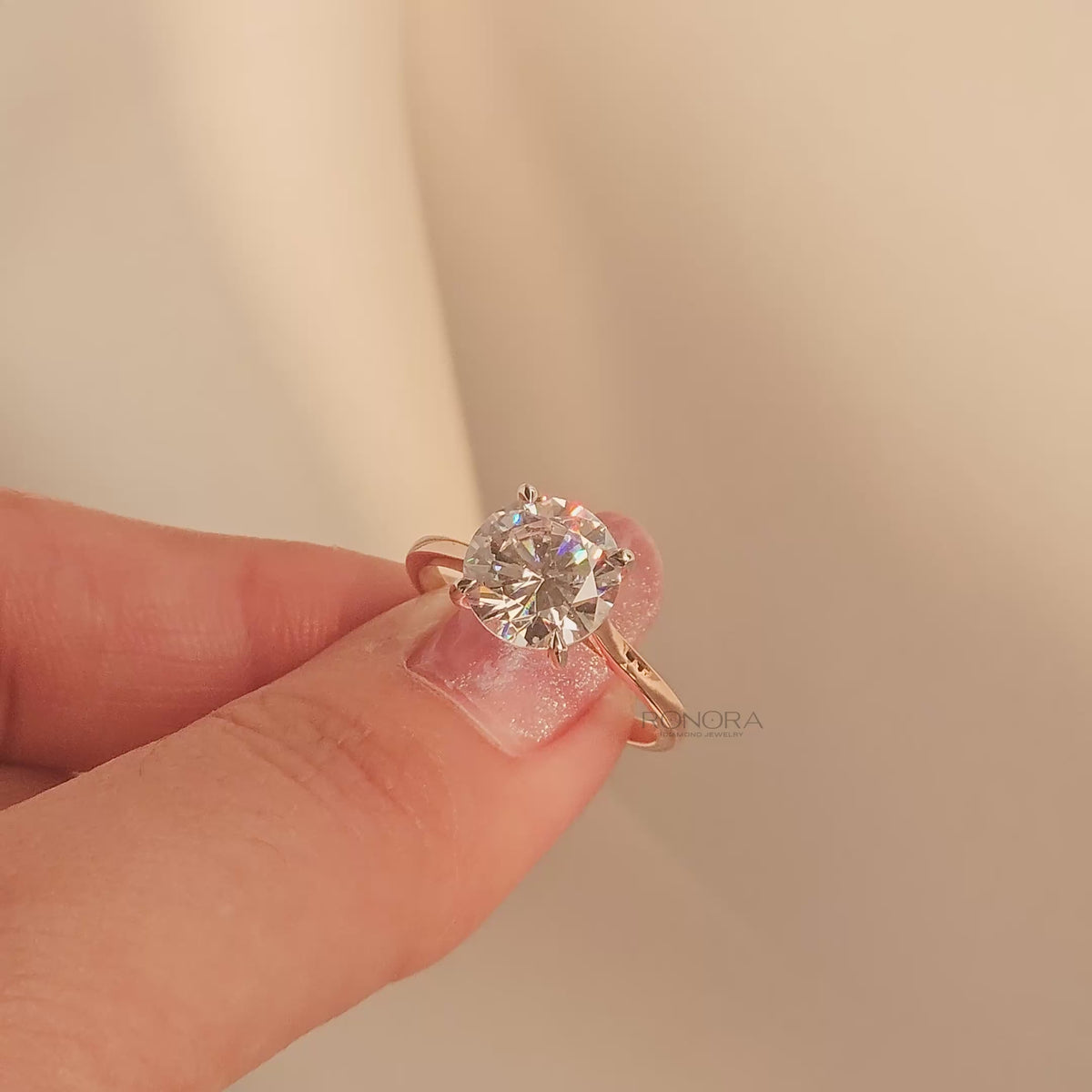 Close-up video of round moissanite solitaire ring in rose gold