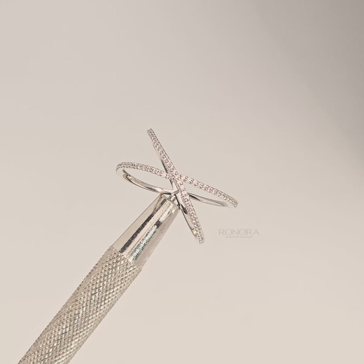 Close-up video of white lab grown diamond pavé crossover ring