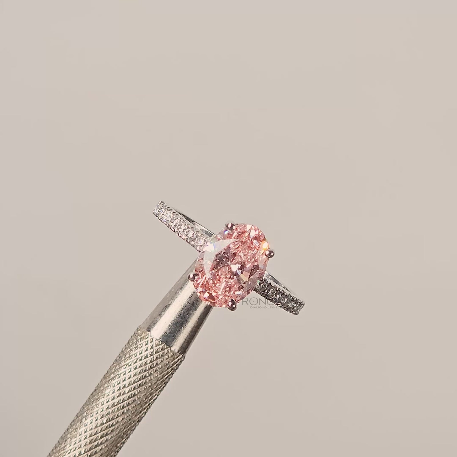 Close-up video of pink oval lab grown diamond halo ring in white gold