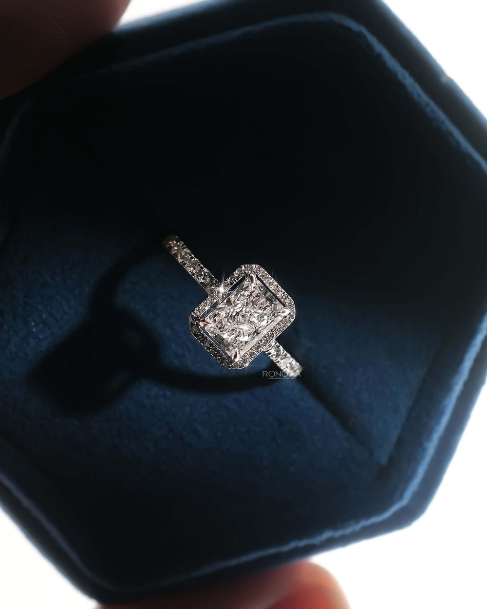 Angled view of radiant lab grown diamond halo ring with halo pave setting