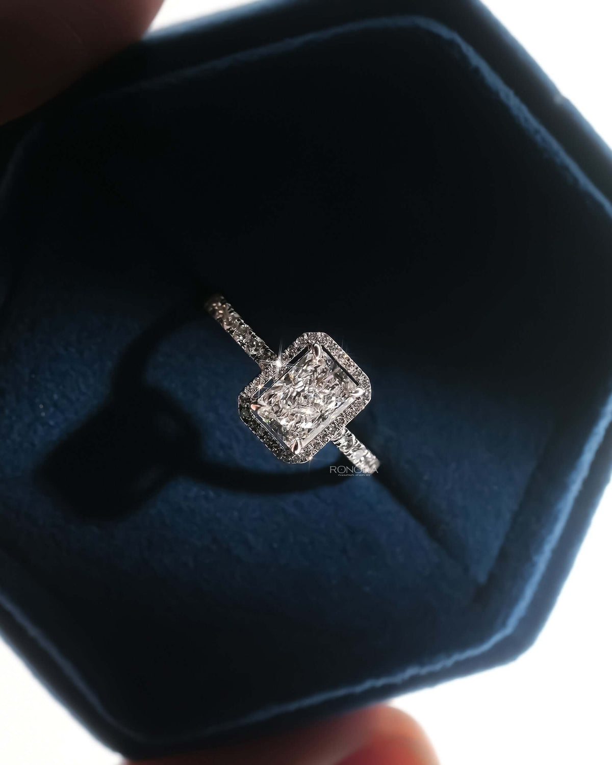 Angled view of radiant lab grown diamond halo ring with halo pave setting