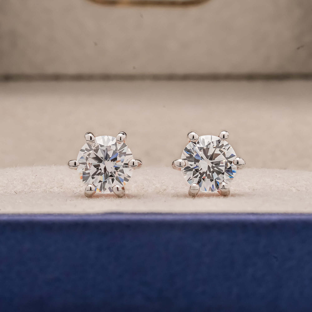 Front view of round lab grown diamond stud earrings inside Ronora box