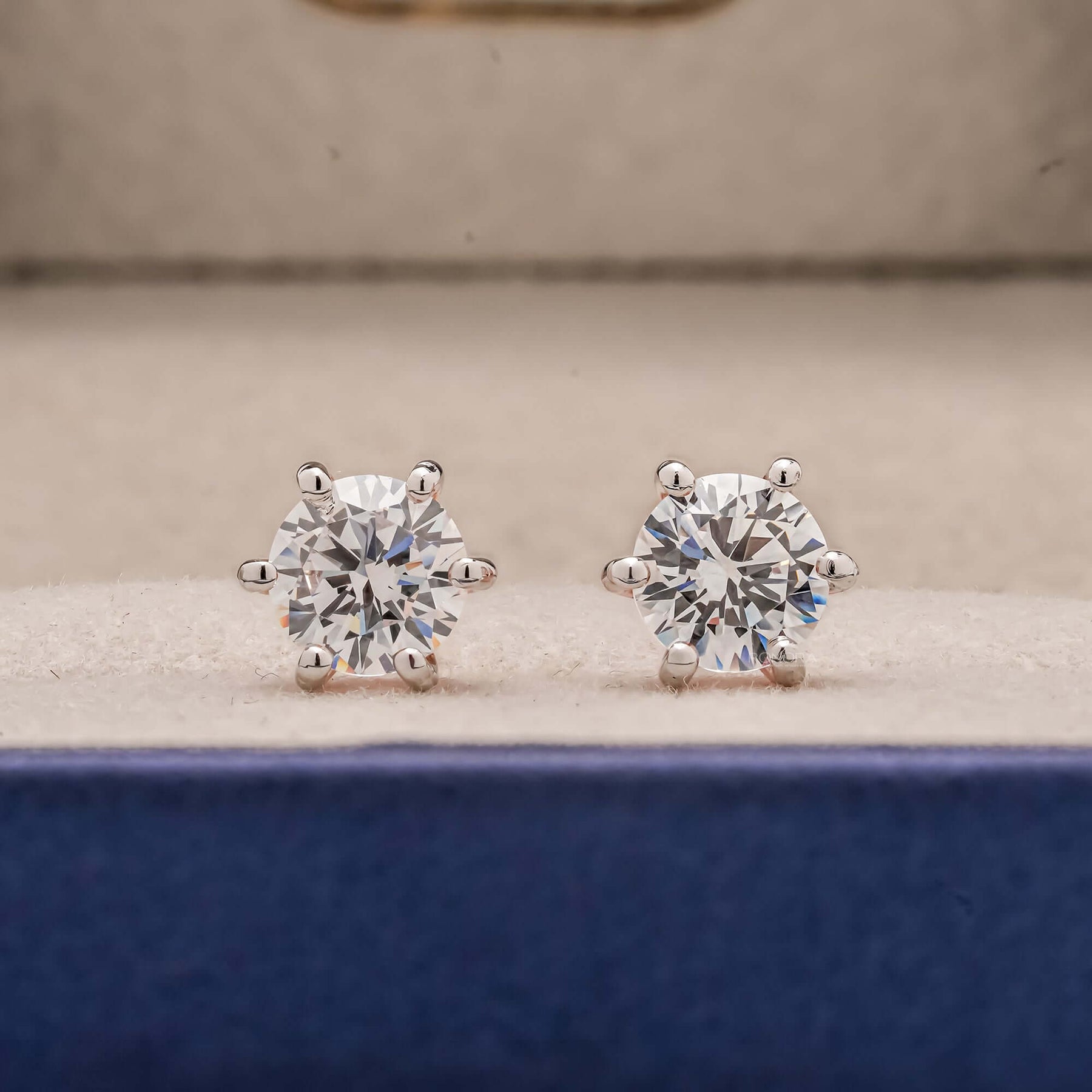 Front view of round lab grown diamond stud earrings inside Ronora box