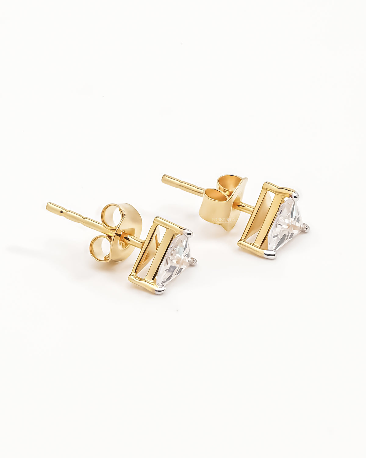Trillion cut lab grown diamond earrings in yellow gold, angled view of the posts and butterfly backs