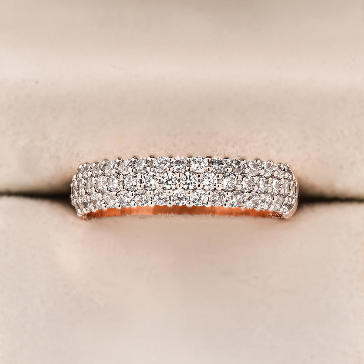 Wide pave lab grown diamond anniversary band in rose gold with rows of round stones, front view in a ring box