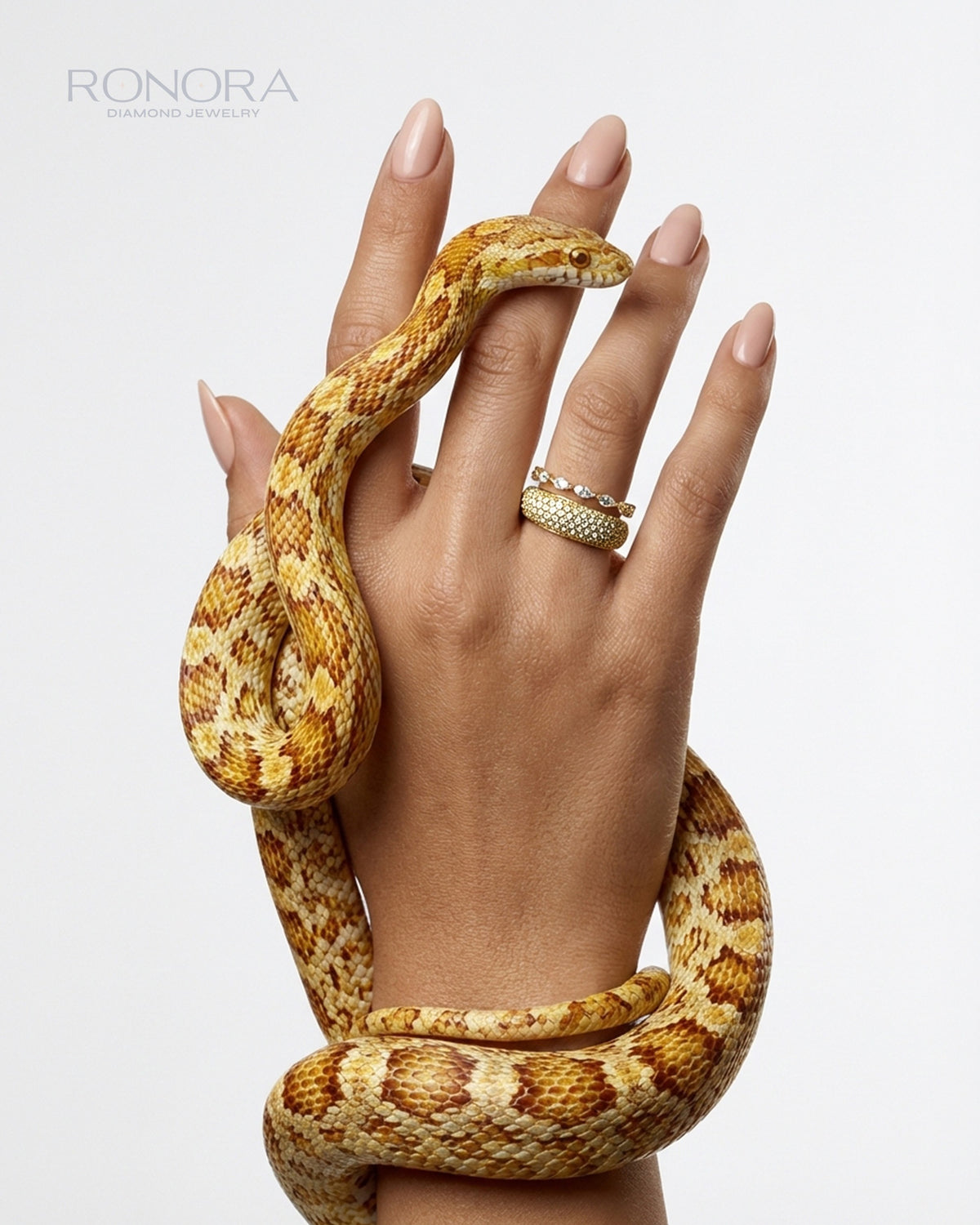 Wide round pave lab grown diamond band in yellow gold stacked with a slim band, worn on a hand with a golden snake