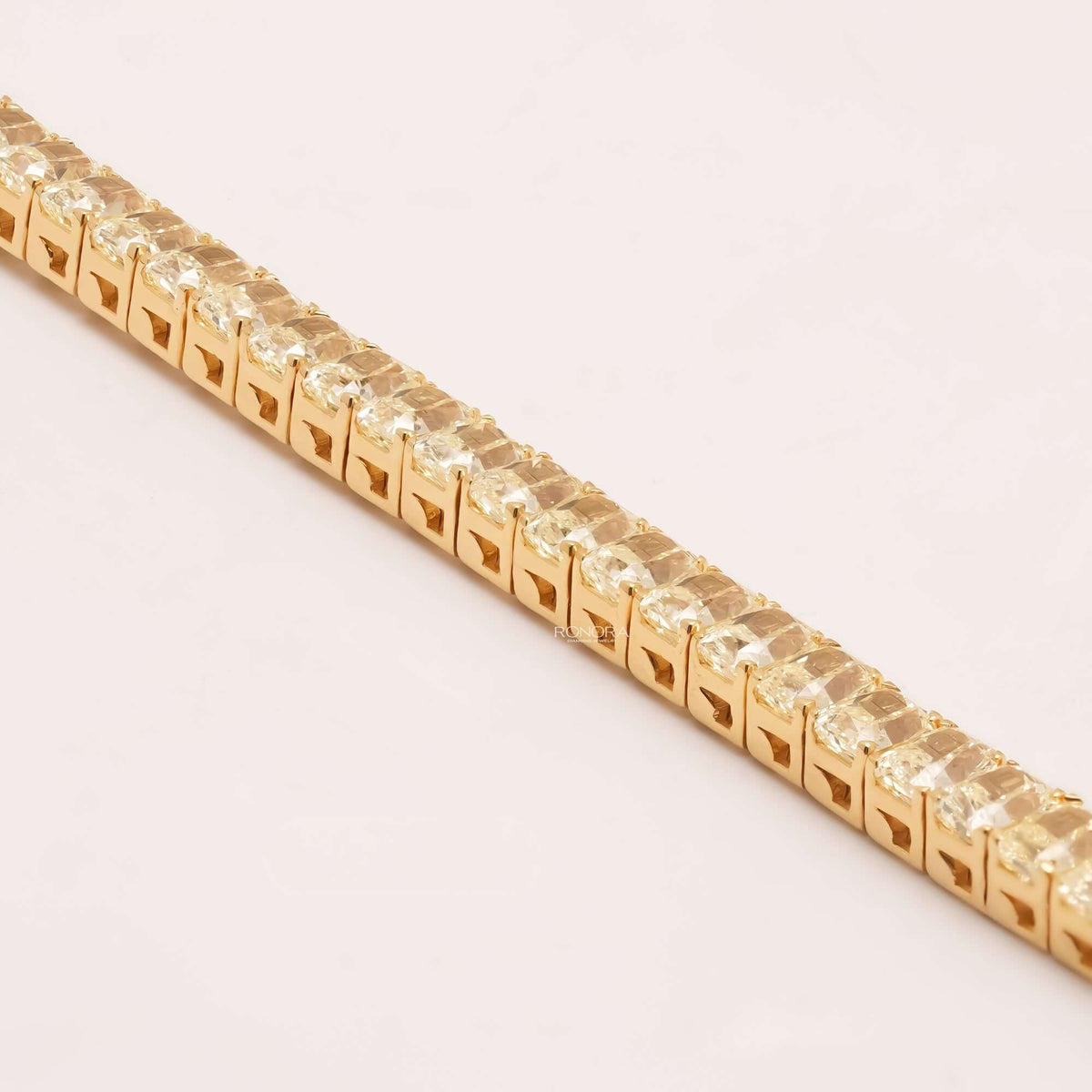 Side detail of radiant yellow lab grown diamond tennis bracelet