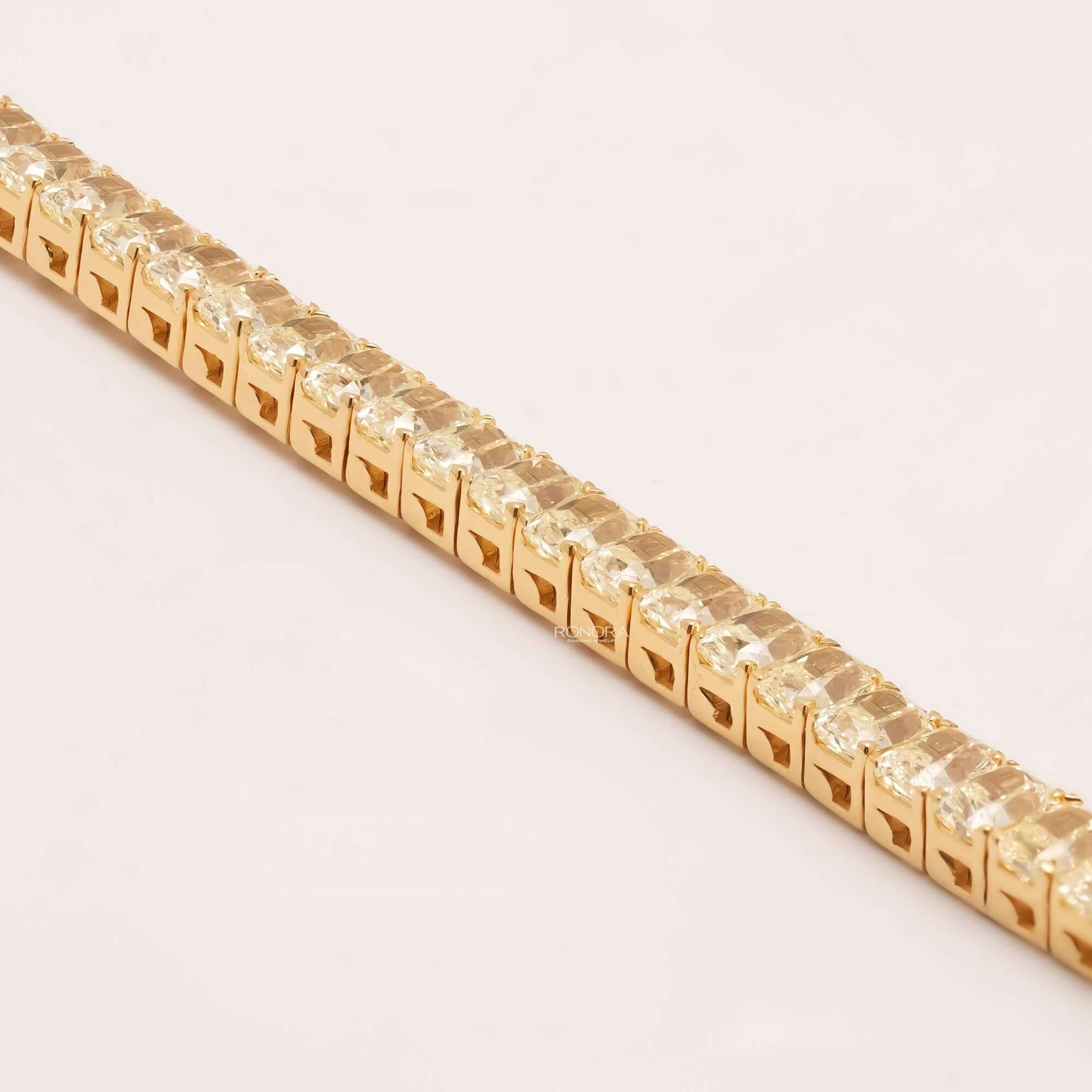 Side detail of radiant yellow lab grown diamond tennis bracelet