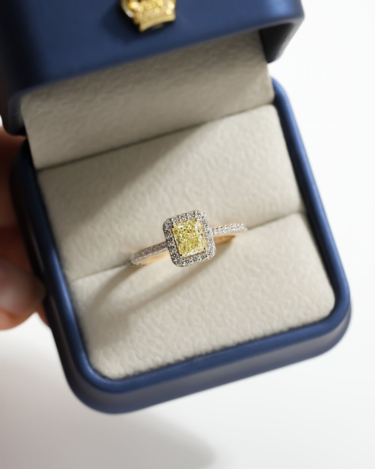 Fancy yellow lab grown diamond halo ring in an open Ronora ring box