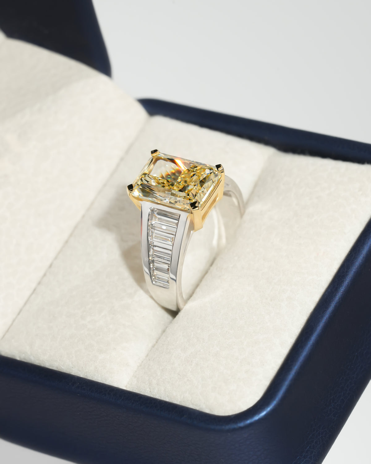 Fancy yellow radiant lab grown diamond ring angled in a Ronora box