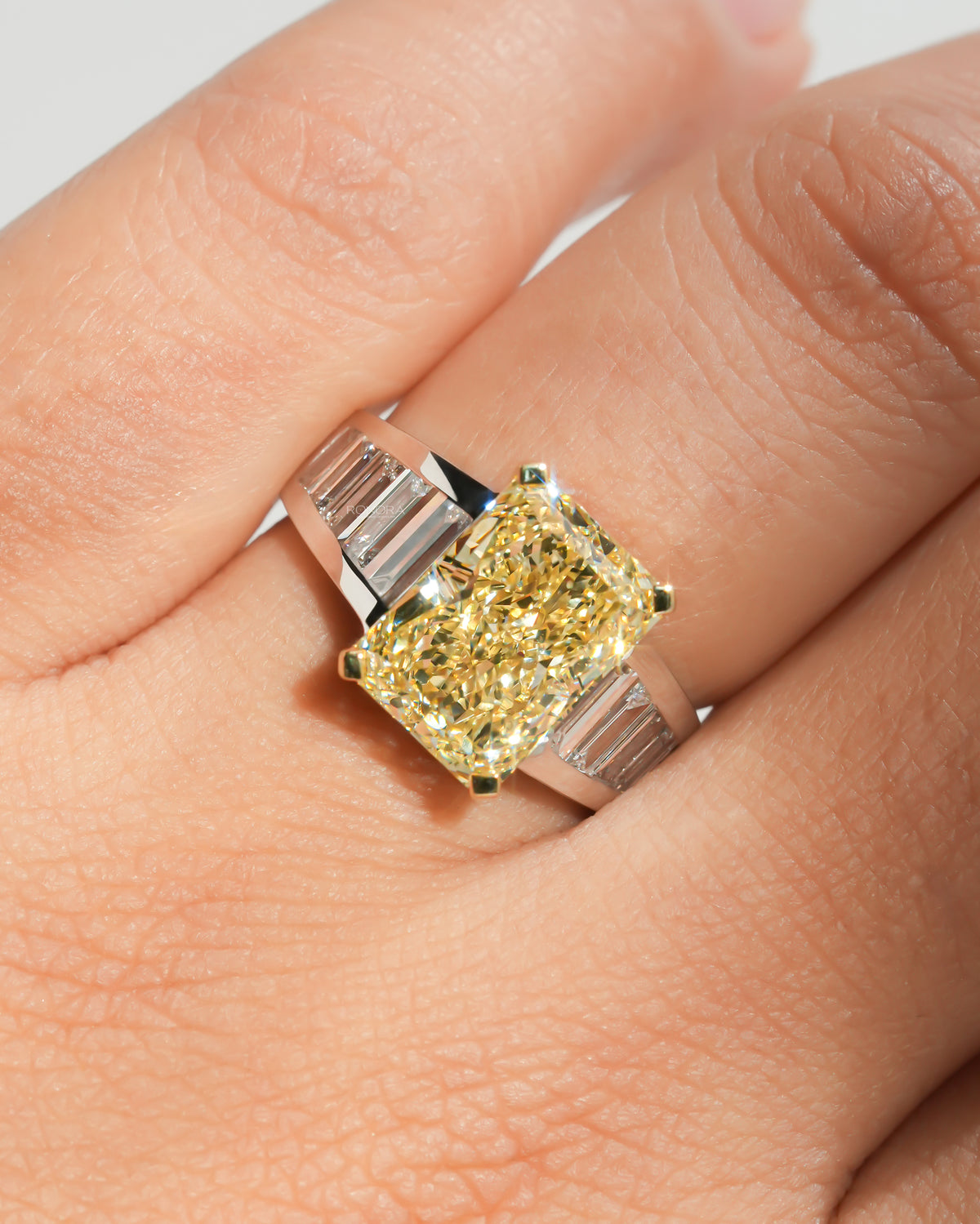 Fancy yellow radiant lab grown diamond ring worn on the hand